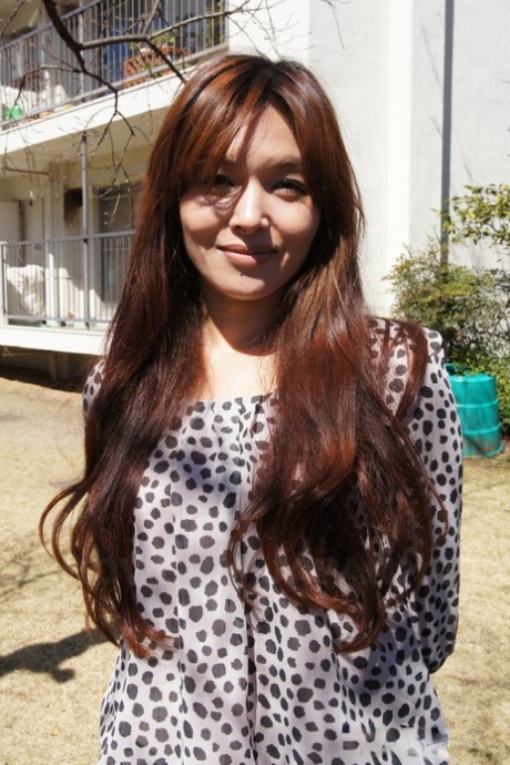Japanese MILF Hitomi Kano wears a nice smile while modeling non nude