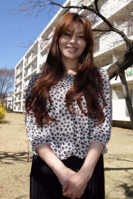 Japanese MILF Hitomi Kano wears a nice smile while modeling non nude