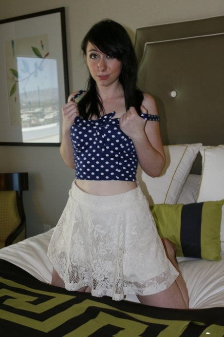 Young brunette girl Dakota Charms unveils her A-cup boobs as she gets naked